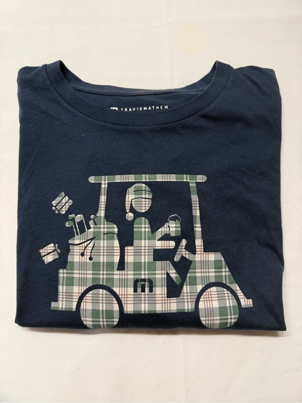 Travis Mathew Navy Short Sleeve Tee with Green Plaid Golf Cart Graphic